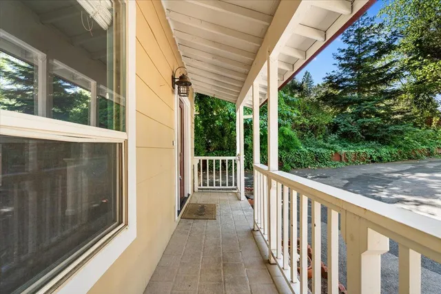 a view of a house with wooden stairs and a small yard