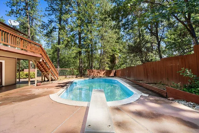 a backyard of a house with lots of trees