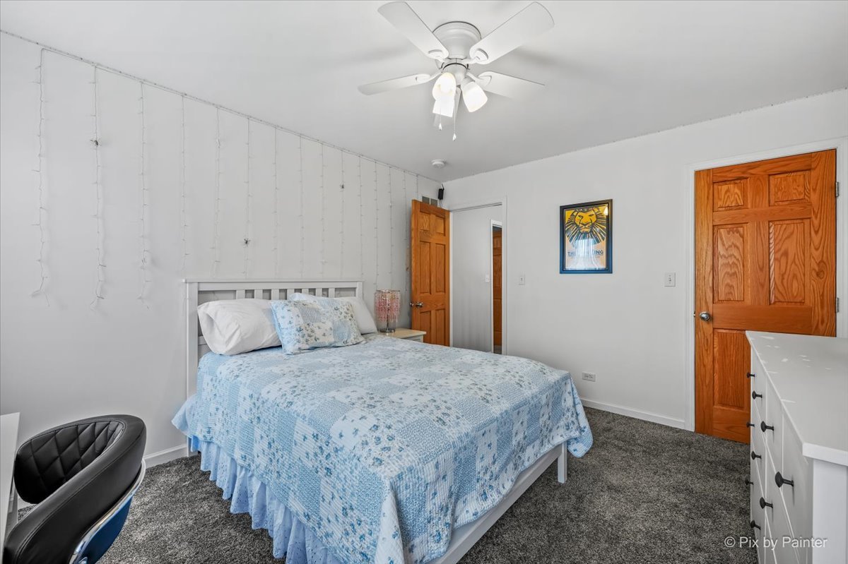 7104 Dove Way Cary, IL 60013 - Photo 35 of 82 a bedroom with a bed and a chandelier