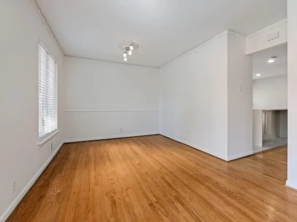 a view of a room with wooden floor and brick walls