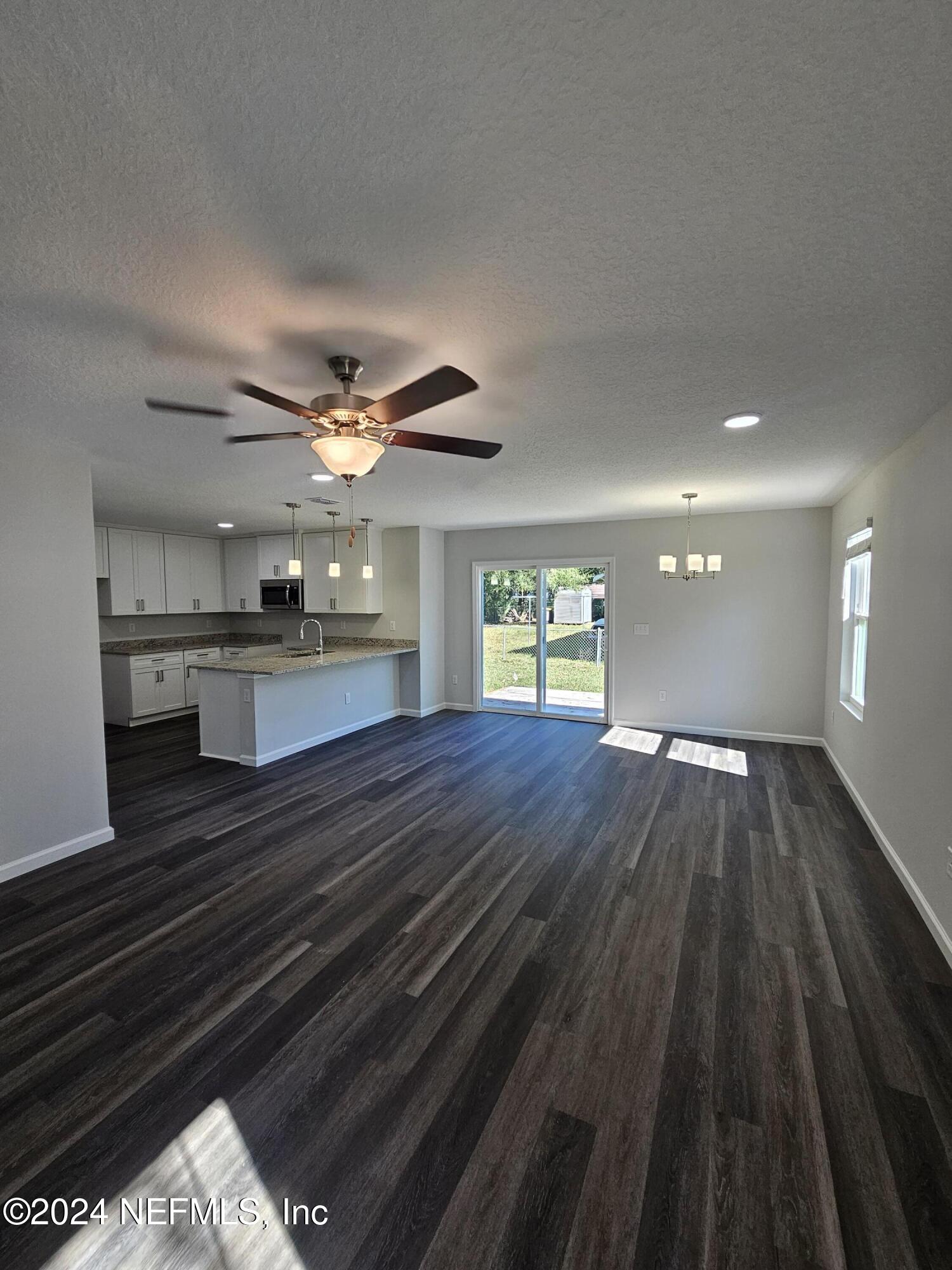 6593 Ricker Road Jacksonville, FL 32244 - Photo 16 of 16 wooden floor in an empty room with a window