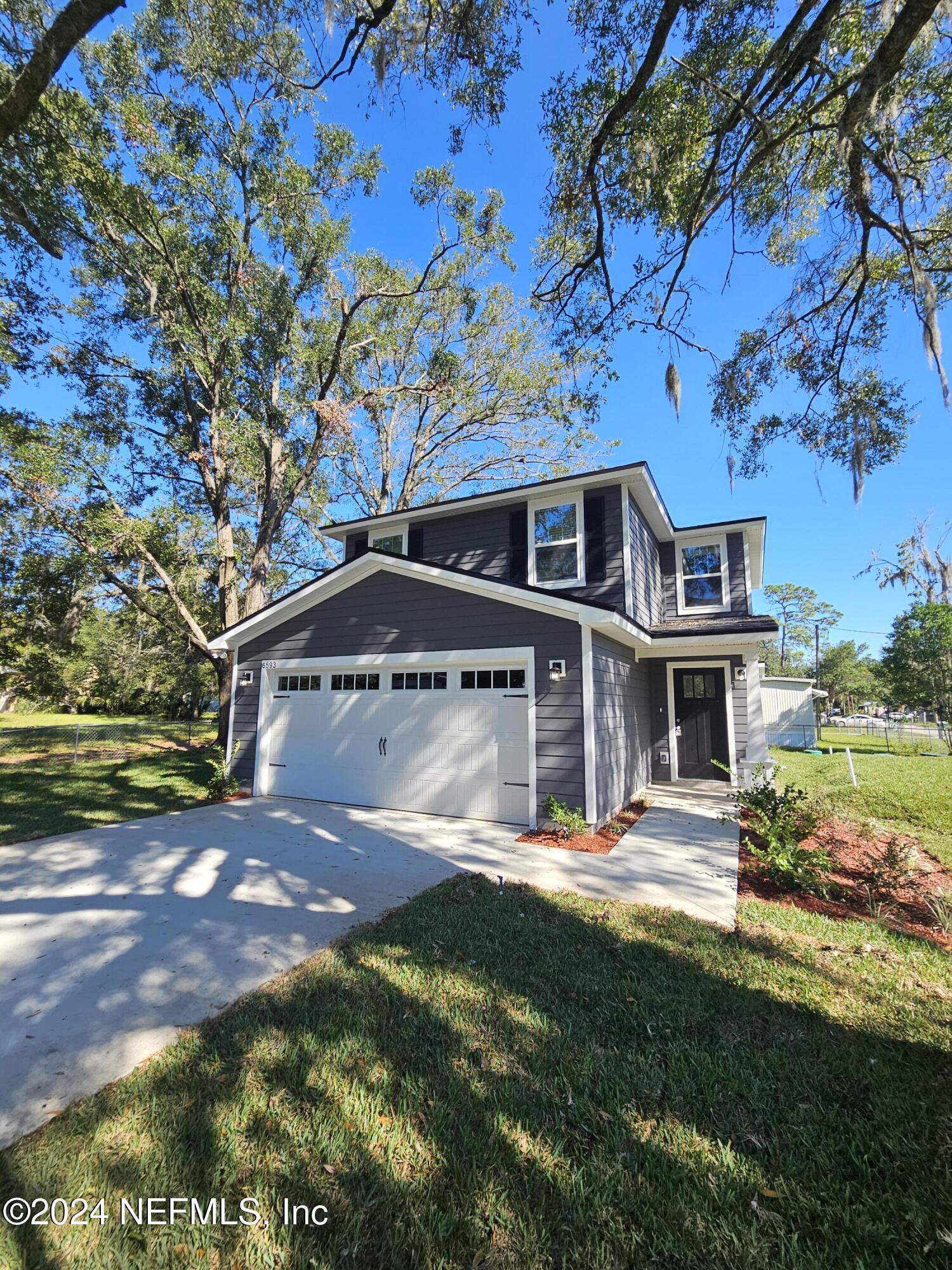 6593 Ricker Road Jacksonville, FL 32244 - Photo 2 of 16 a front view of a house with garden