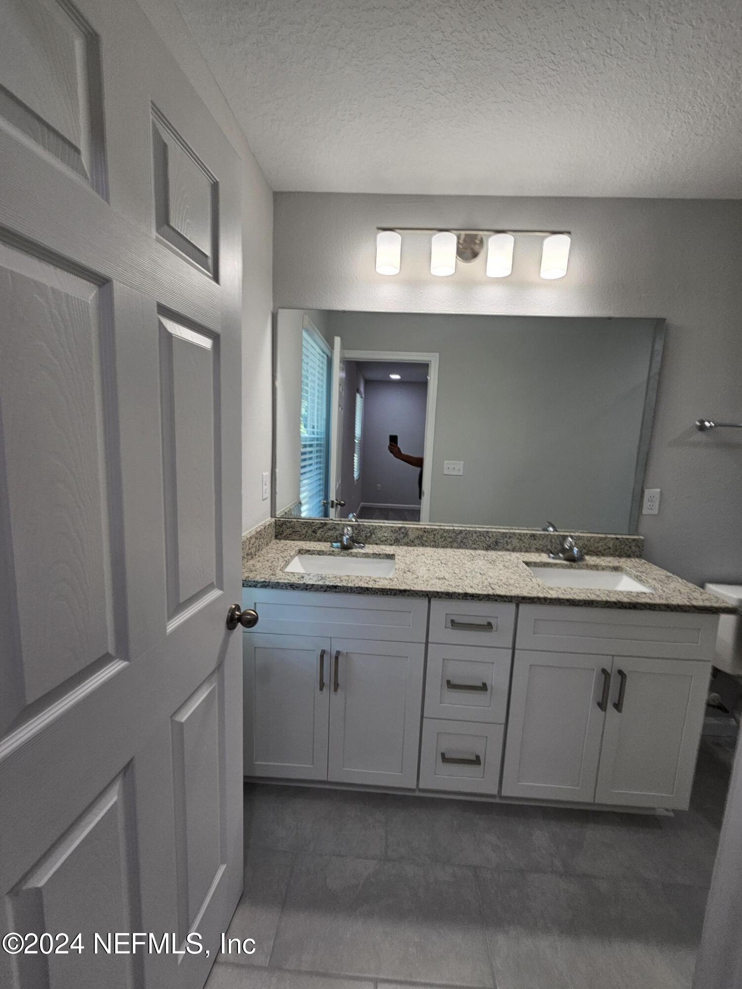 6593 Ricker Road Jacksonville, FL 32244 - Photo 3 of 16 a bathroom with a sink and a mirror