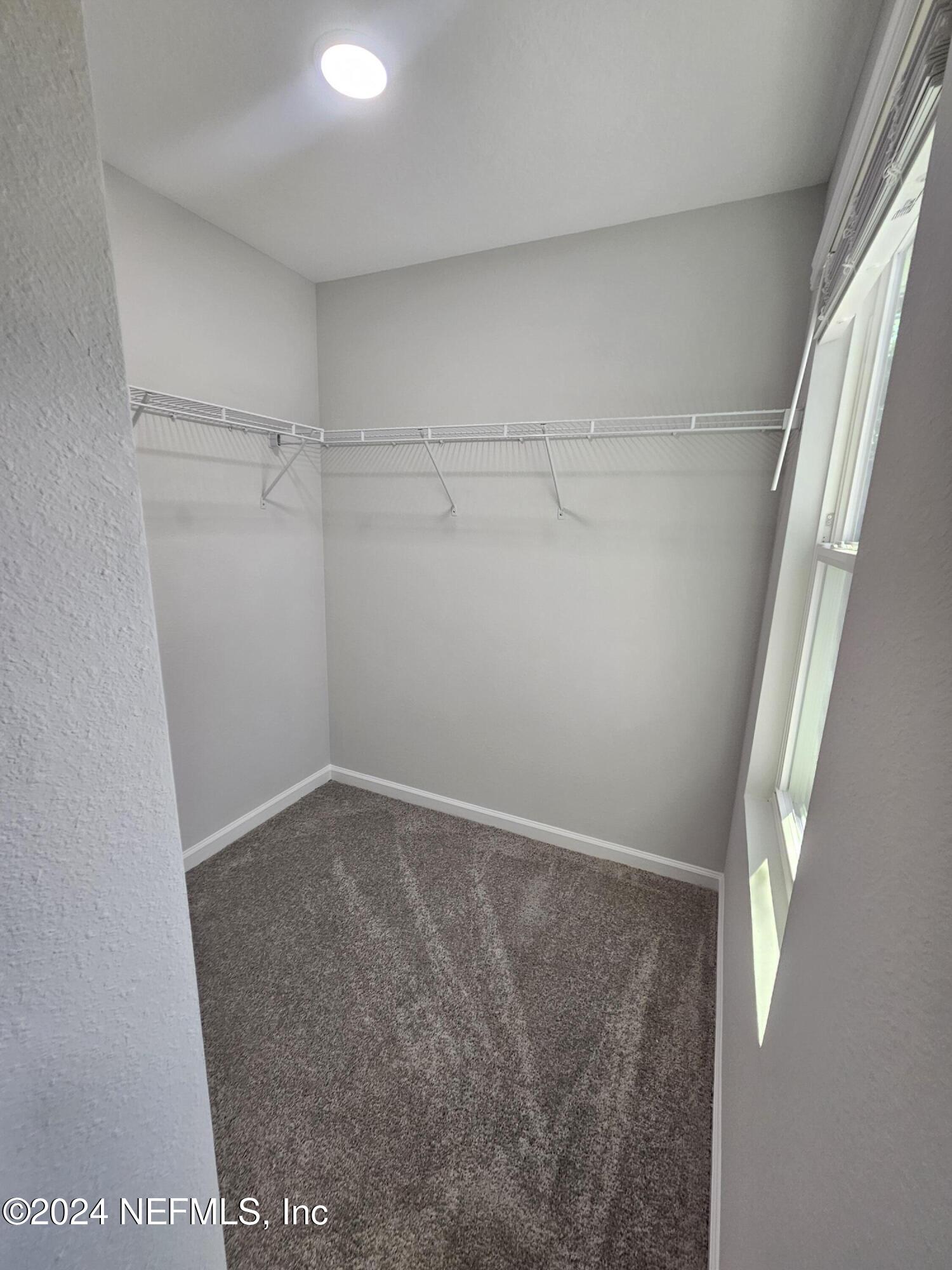 6593 Ricker Road Jacksonville, FL 32244 - Photo 4 of 16 a view of a room with racks on the wall