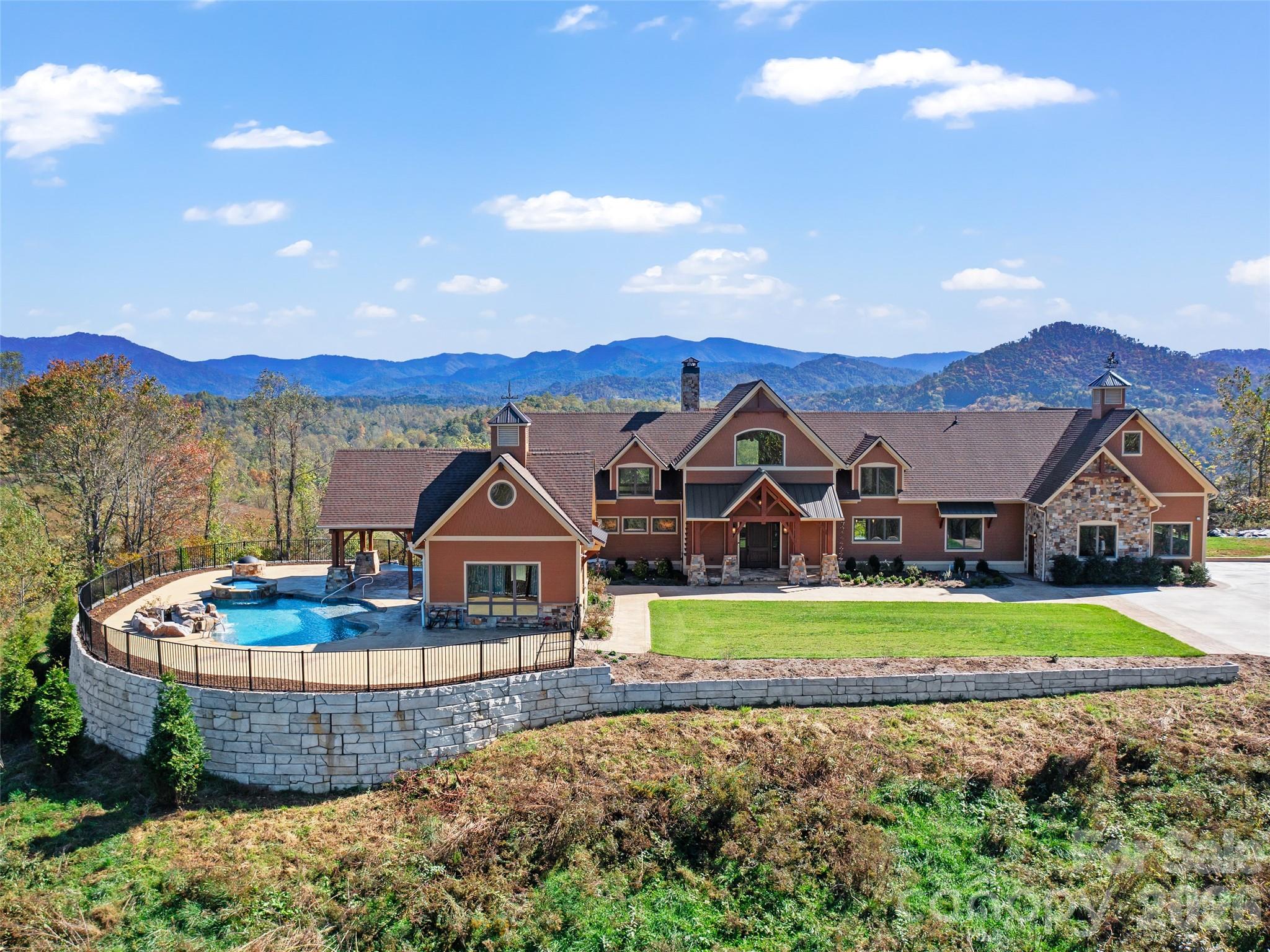 a view of a big house with a big yard and large tree