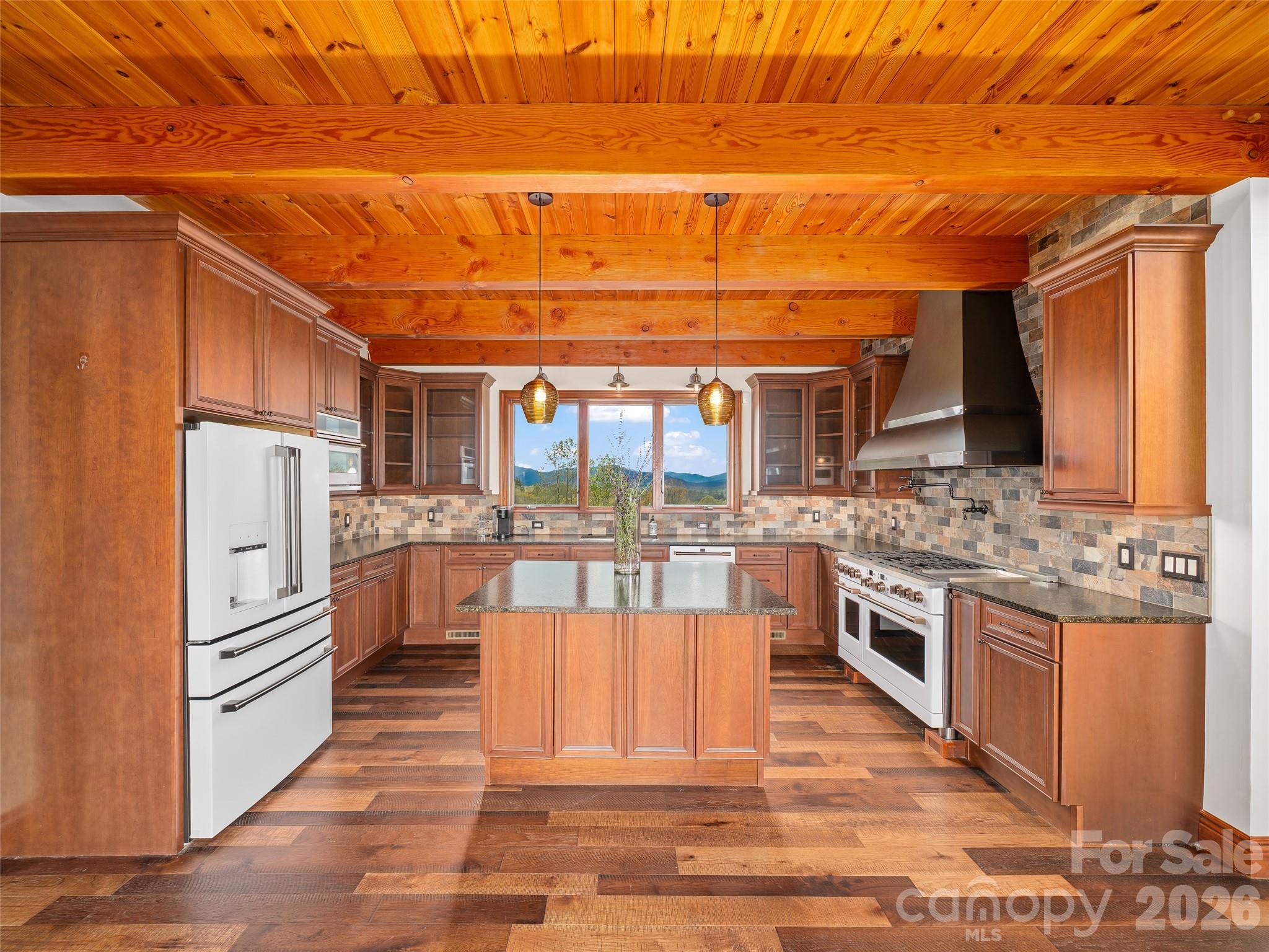 946 Ridge Road Green Mountain, NC 28740 - Photo 16 of 48 a large kitchen with stainless steel appliances wooden cabinets and a counter top space