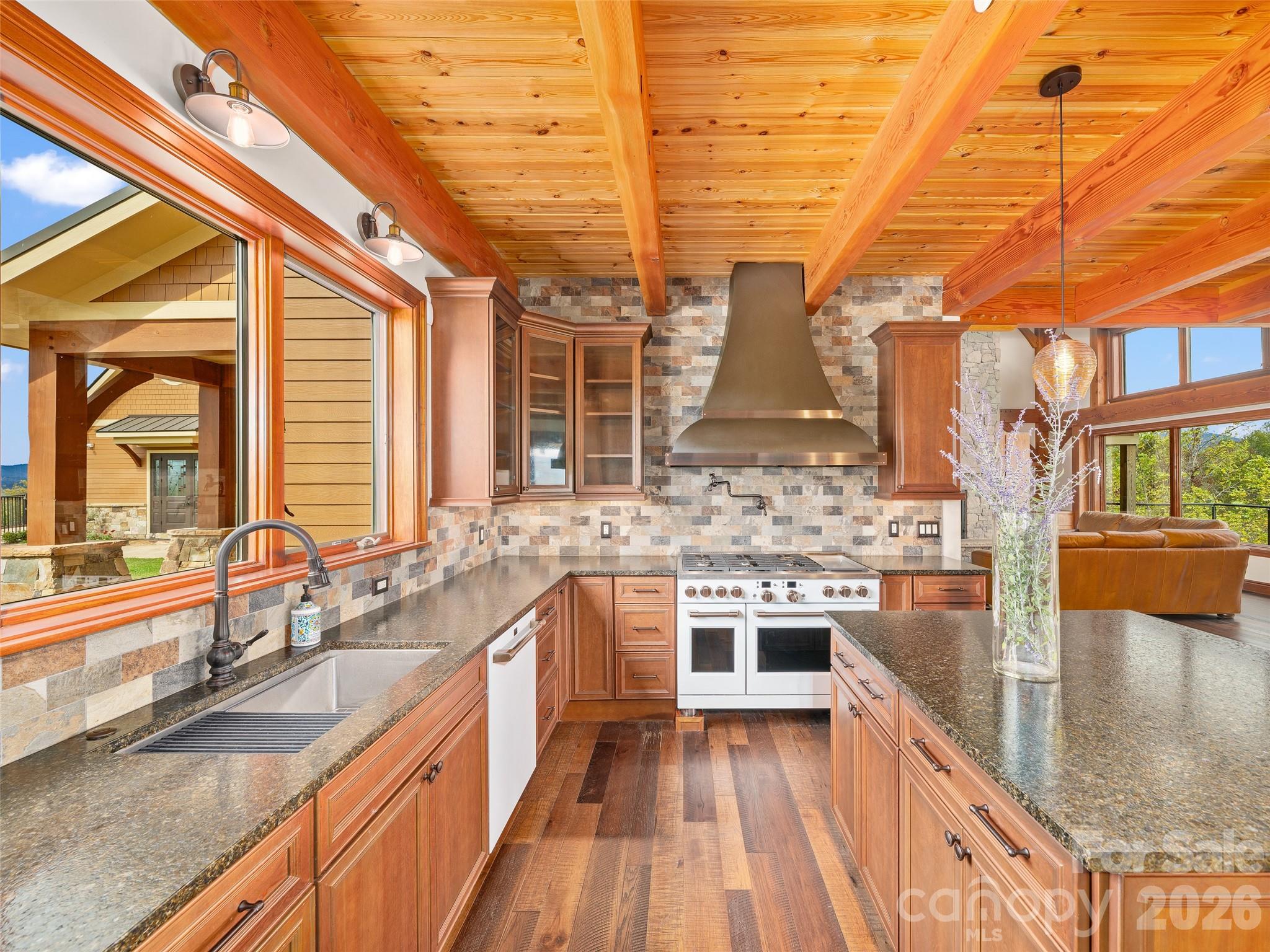 946 Ridge Road Green Mountain, NC 28740 - Photo 18 of 48 a large kitchen with stainless steel appliances granite countertop a sink and stove