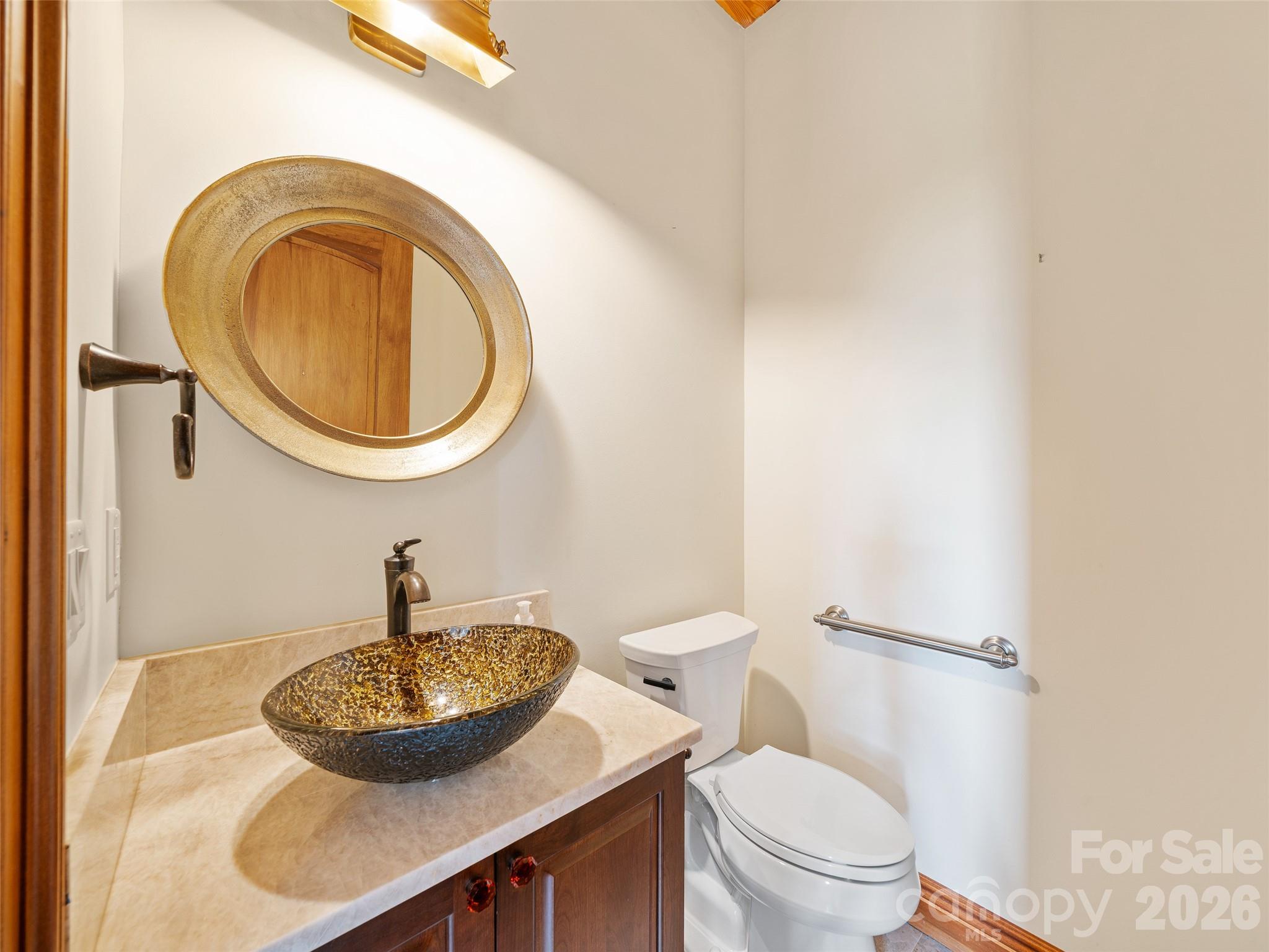 946 Ridge Road Green Mountain, NC 28740 - Photo 31 of 48 a bathroom with a granite countertop toilet and a sink