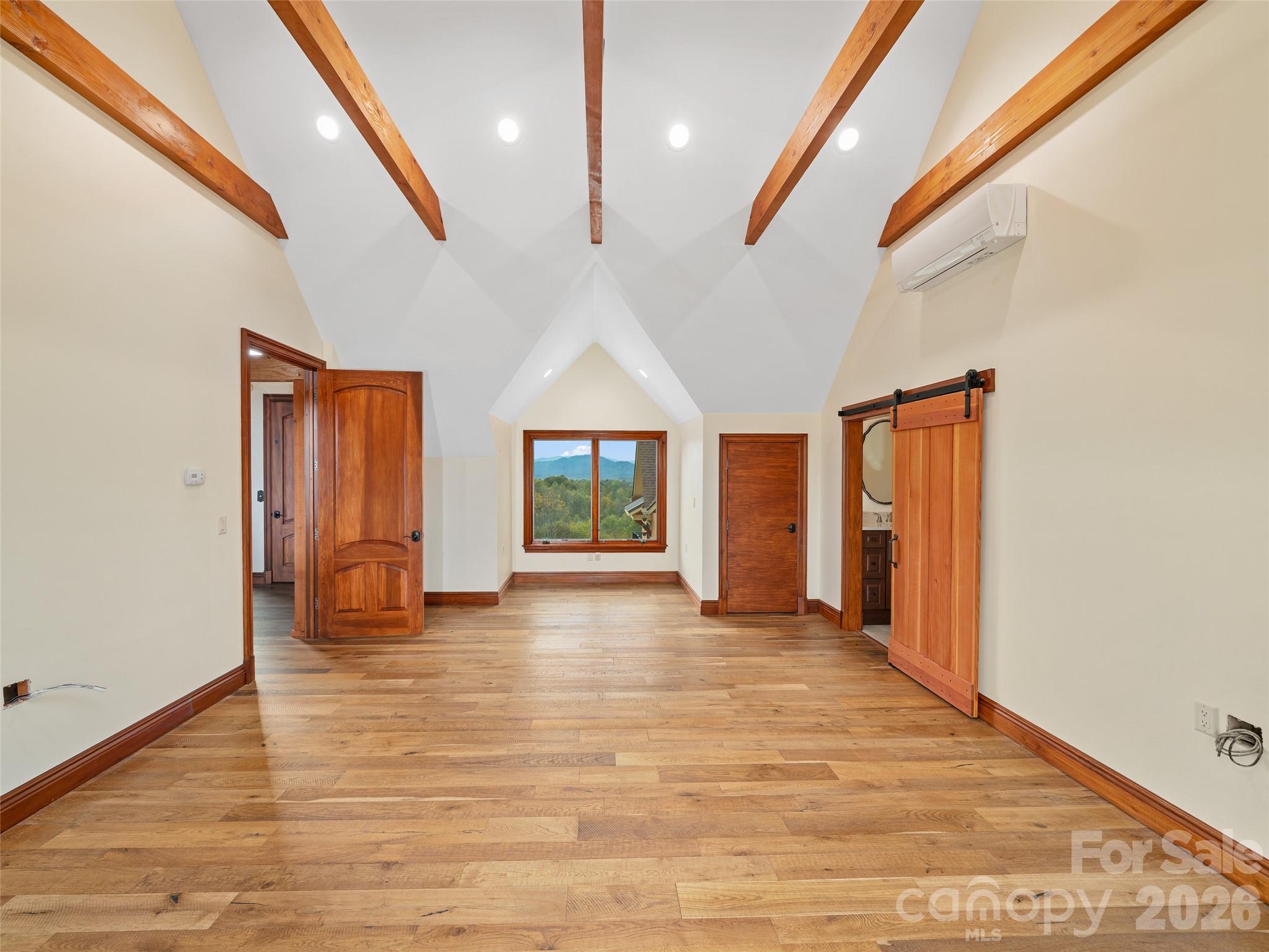 946 Ridge Road Green Mountain, NC 28740 - Photo 37 of 48 a view of an empty room with wooden floor and a window