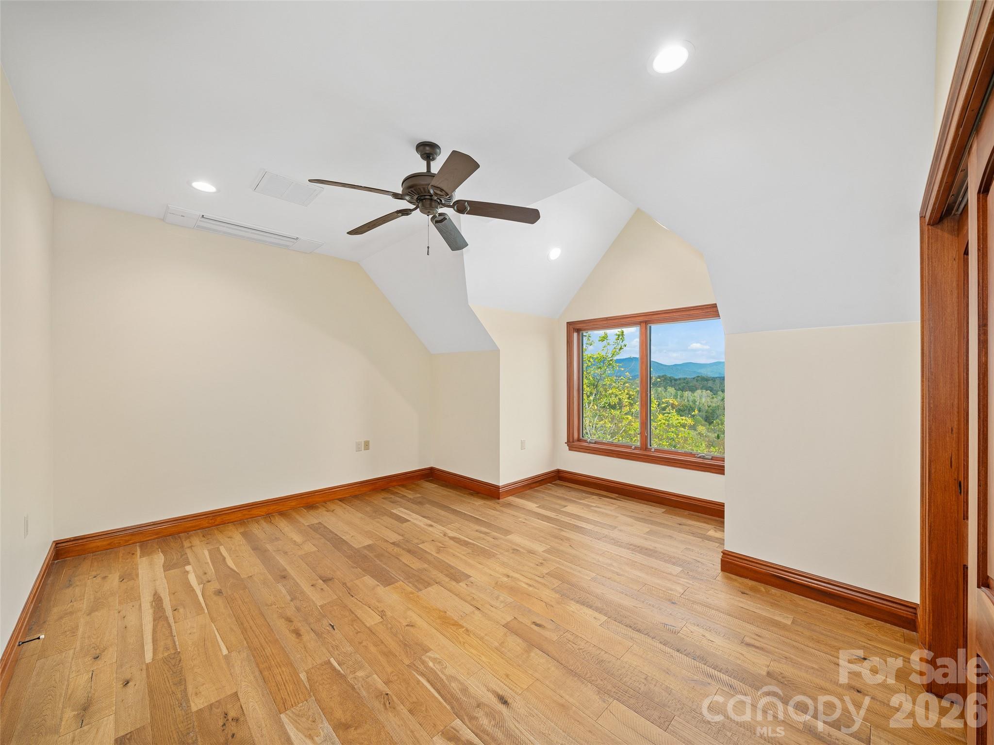 946 Ridge Road Green Mountain, NC 28740 - Photo 39 of 48 a view of empty room with wooden floor and fan