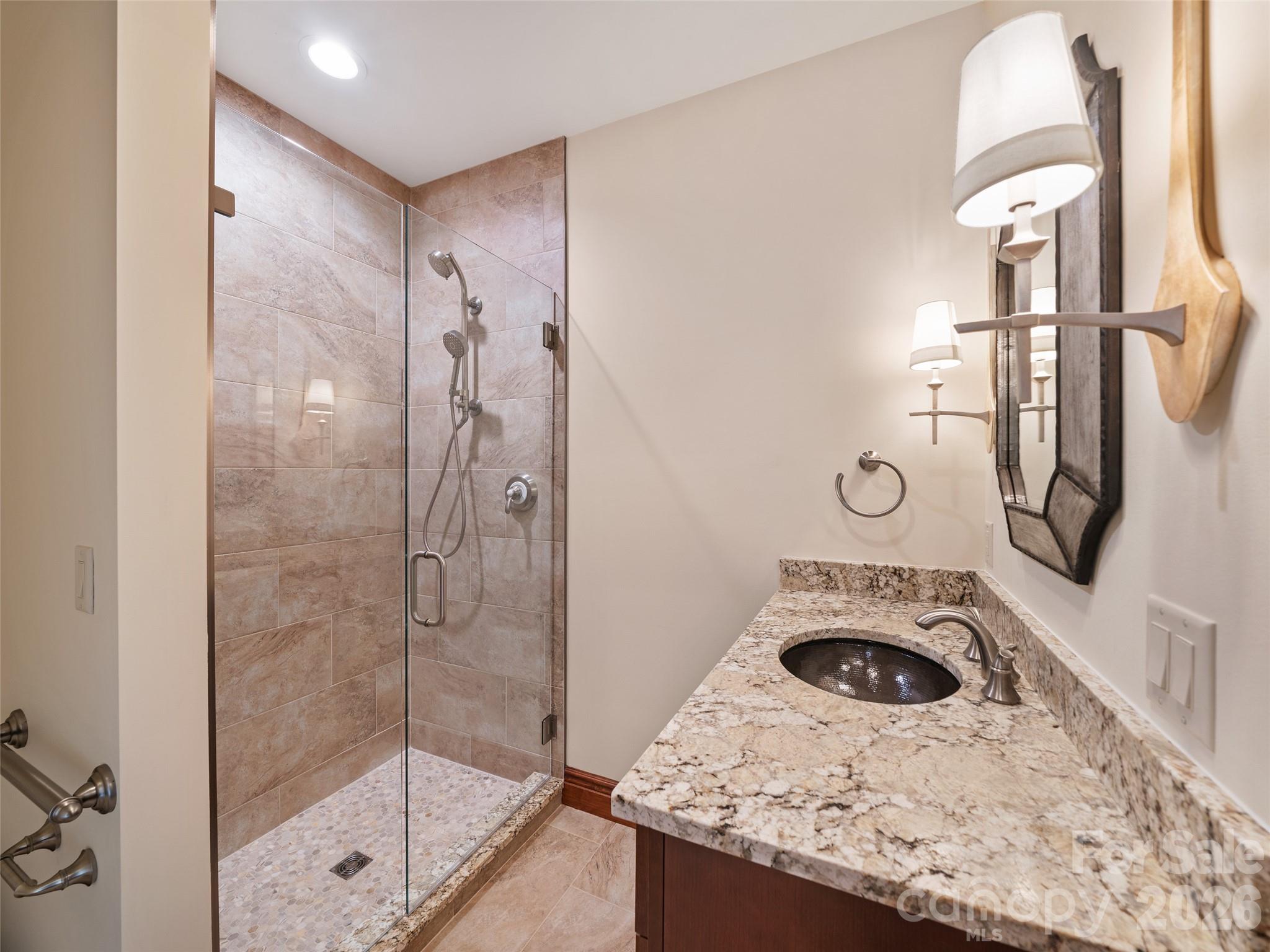 946 Ridge Road Green Mountain, NC 28740 - Photo 40 of 48 a bathroom with a sink a mirror and shower