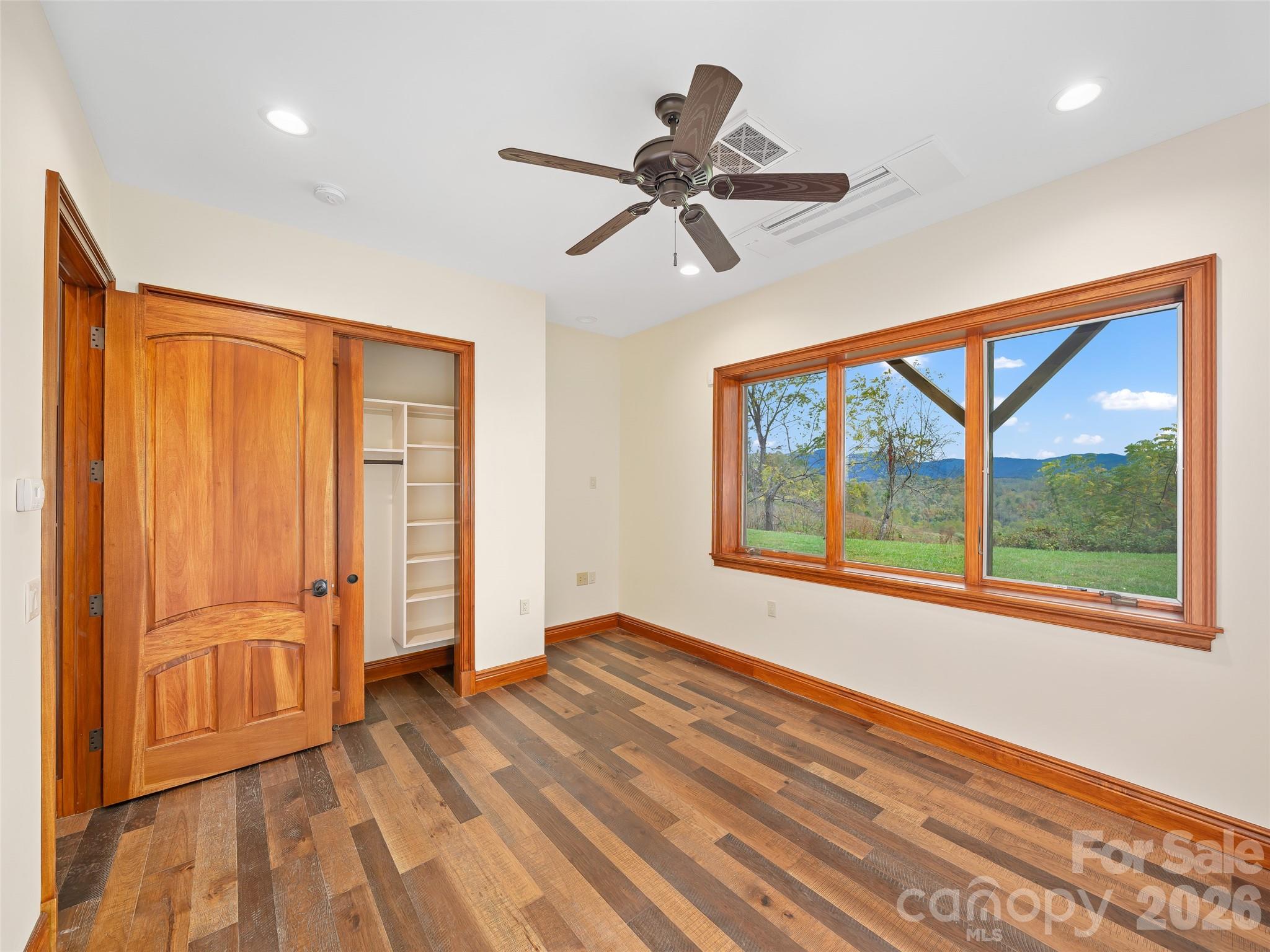 946 Ridge Road Green Mountain, NC 28740 - Photo 42 of 48 a view of an empty room with a window and wooden floor