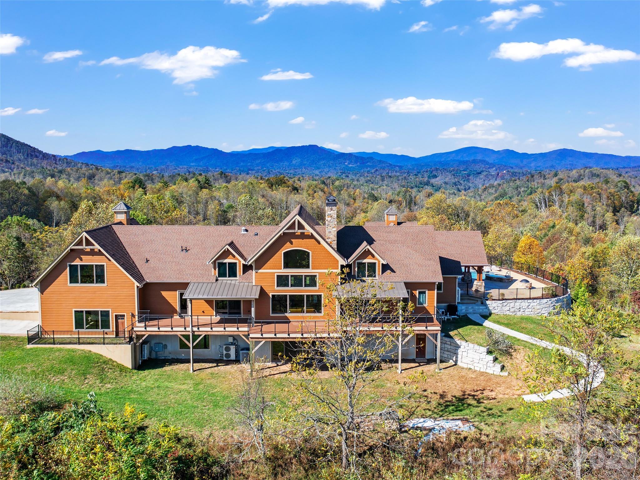 946 Ridge Road Green Mountain, NC 28740 - Photo 5 of 48 a view of a large house with a big yard and large trees
