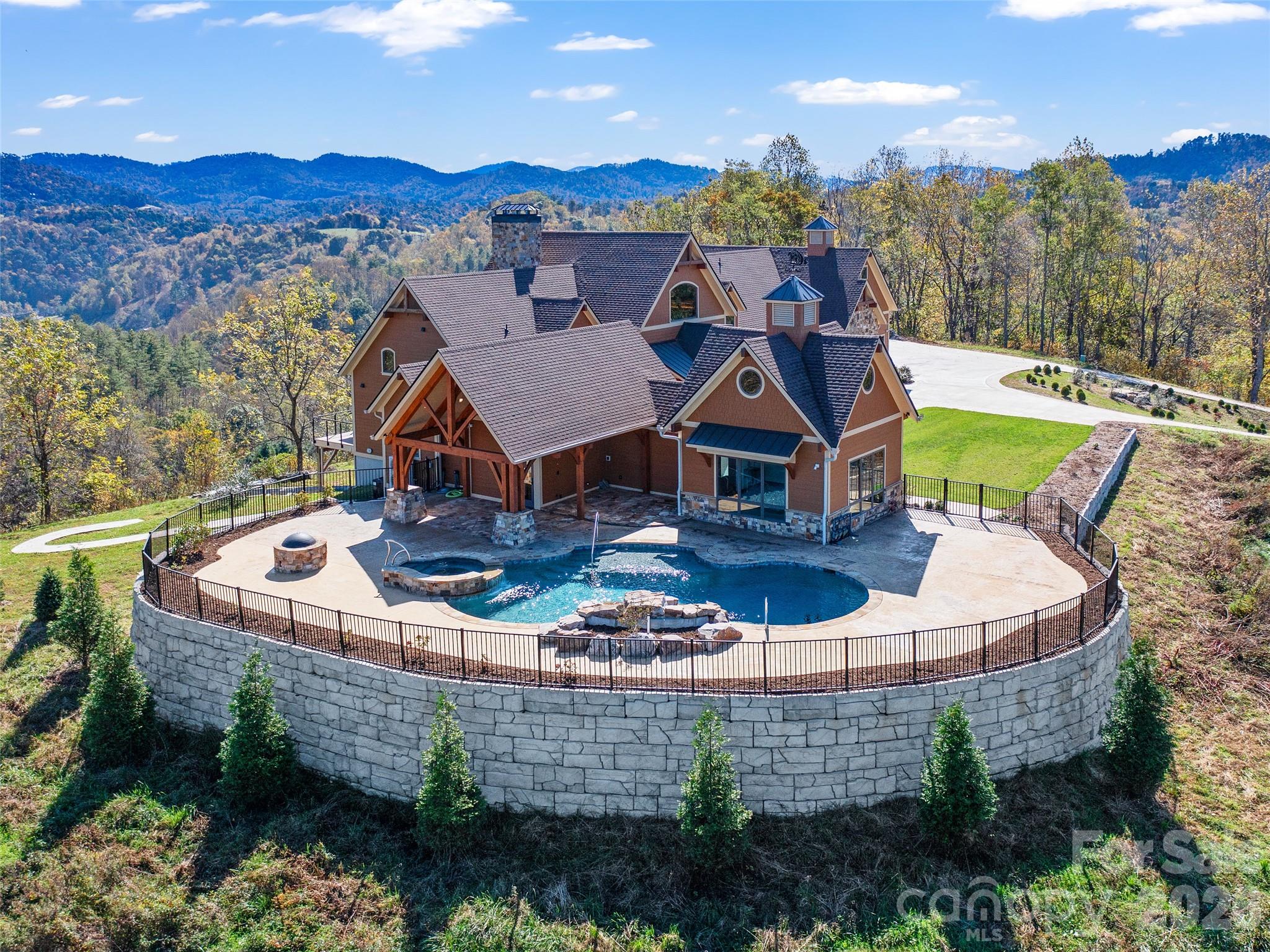 946 Ridge Road Green Mountain, NC 28740 - Photo 10 of 48 an aerial view of a house with swimming pool and a yard