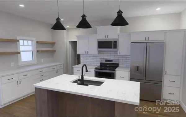 a kitchen with stainless steel appliances a sink a refrigerator a stove a microwave and cabinets