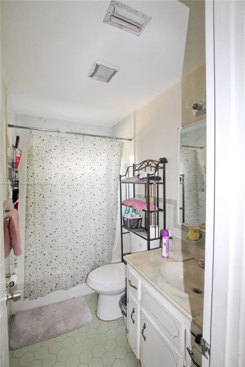 1401 Bassage Road Sebring, FL 33875 - Photo 13 of 18 a bathroom with a sink a toilet and shower