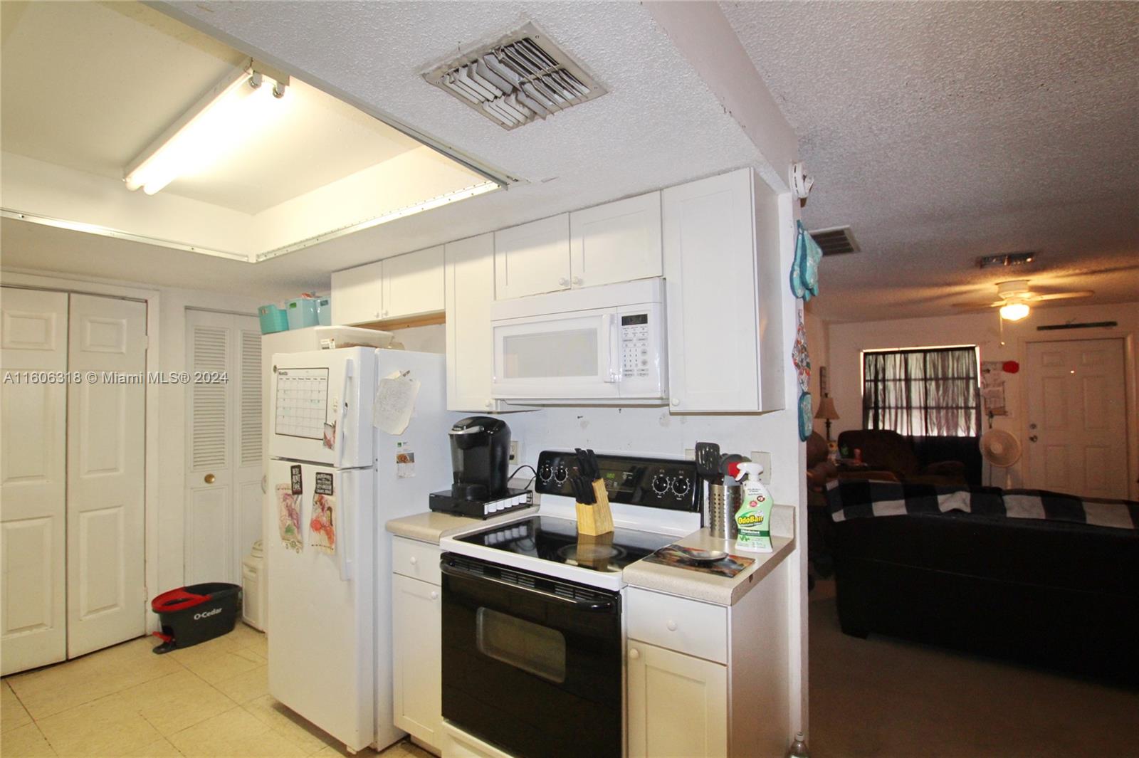 1401 Bassage Road Sebring, FL 33875 - Photo 6 of 18 a kitchen with stainless steel appliances a stove a refrigerator and a refrigerator