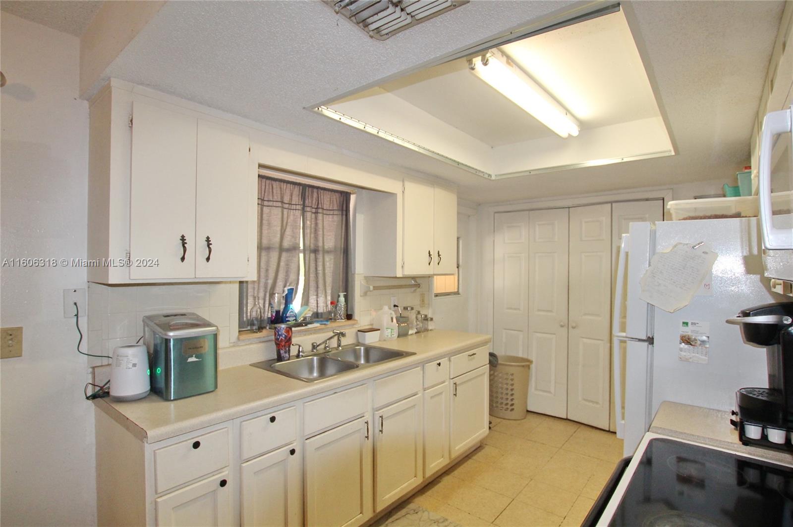 1401 Bassage Road Sebring, FL 33875 - Photo 7 of 18 a kitchen with sink refrigerator and cabinets