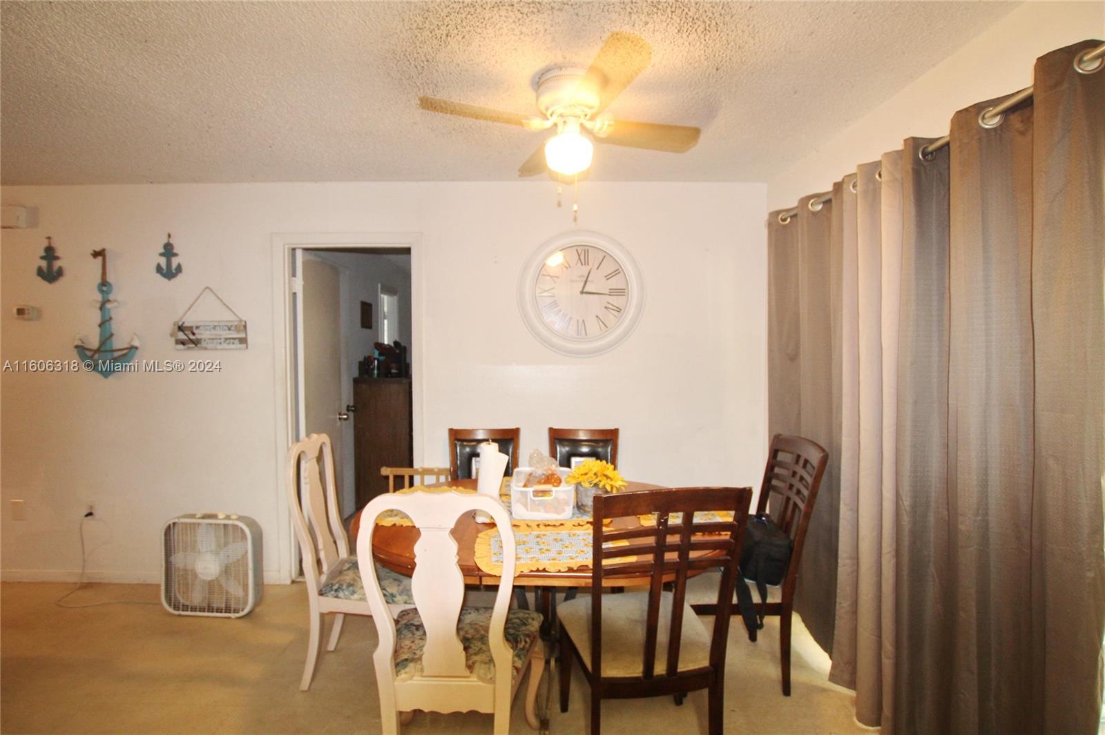1401 Bassage Road Sebring, FL 33875 - Photo 9 of 18 a view of a dining room with furniture and a chandelier