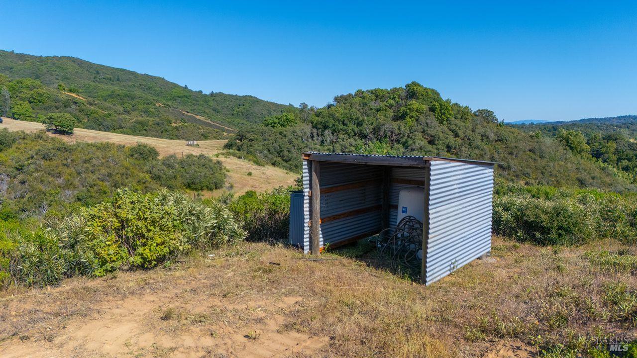 31909 Green Road Cloverdale, CA 95425 - Photo 7 of 25 a view of a wooden house with a yard