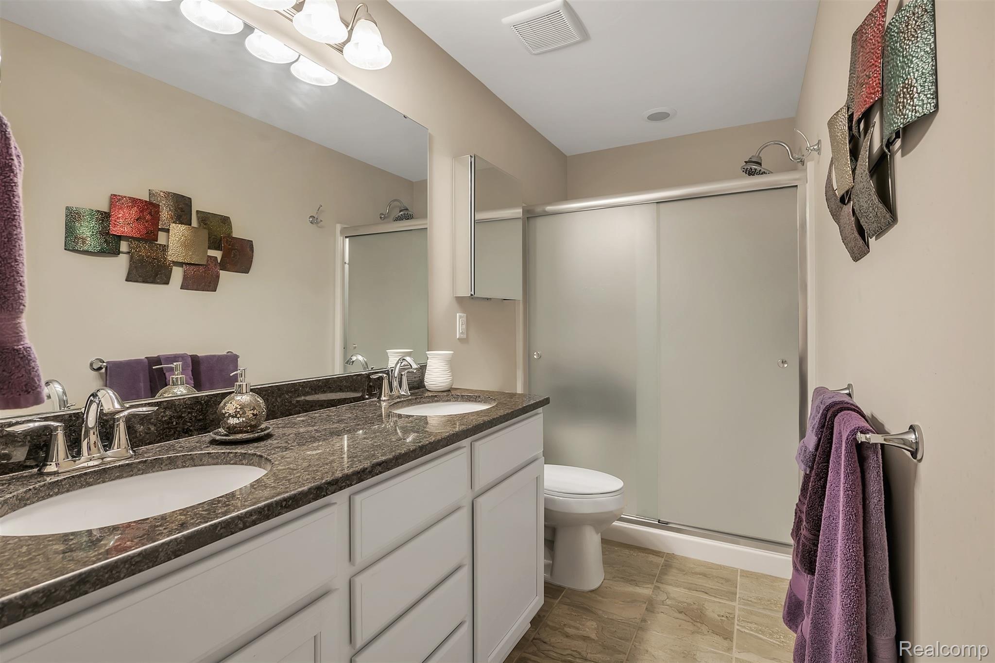 147 Sedum Road Howell, MI 48843 - Photo 13 of 34 En Suite Master Bathroom with Dual Vanity and Walk In Shower with Euro Doors