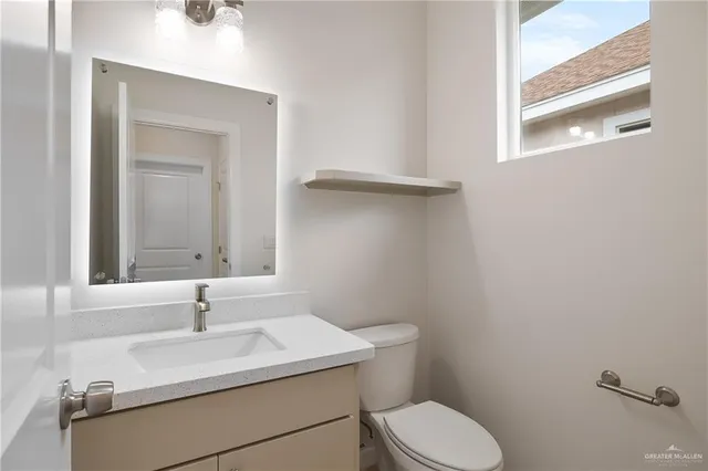 a bathroom with a sink toilet and mirror