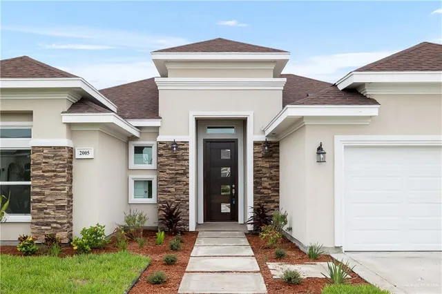a front view of a house with garden