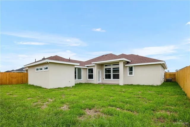 a view of a house with yard and sitting area