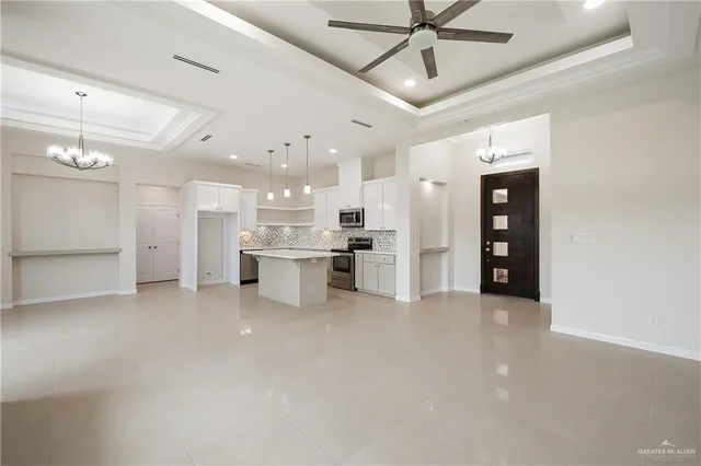 a view of kitchen with refrigerator and window