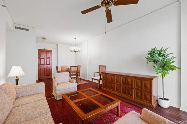 a living room with furniture and a potted plant