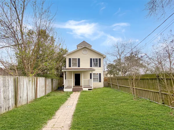 a front view of a house with a yard table and chairs