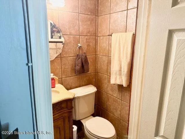 a white toilet sitting next to a small bathroom