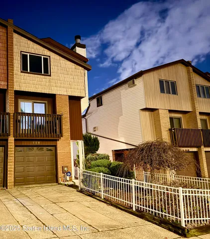 a view of a house with wooden fence