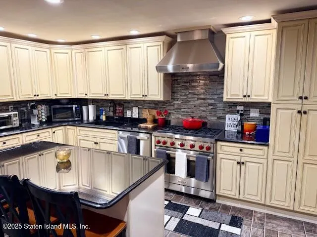 a kitchen with stainless steel appliances granite countertop a sink a stove and a cabinets