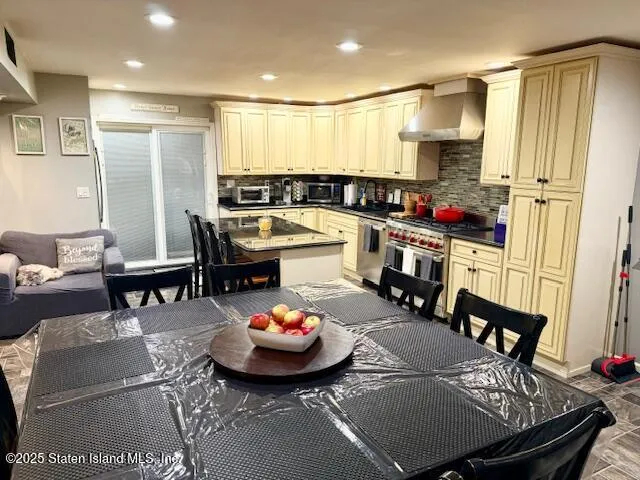 a kitchen with a sink a stove and chairs