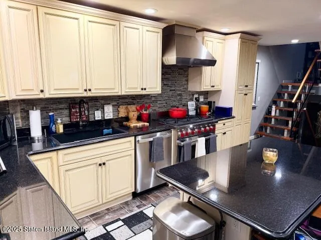 a kitchen with stainless steel appliances granite countertop a stove a sink and a refrigerator