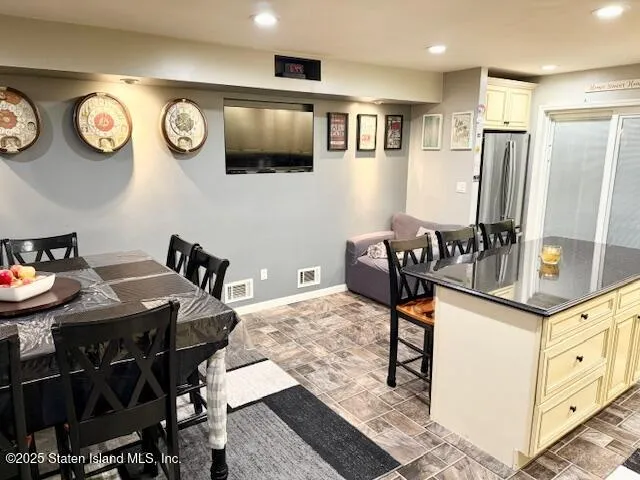 a view of a kitchen with dining table and chairs