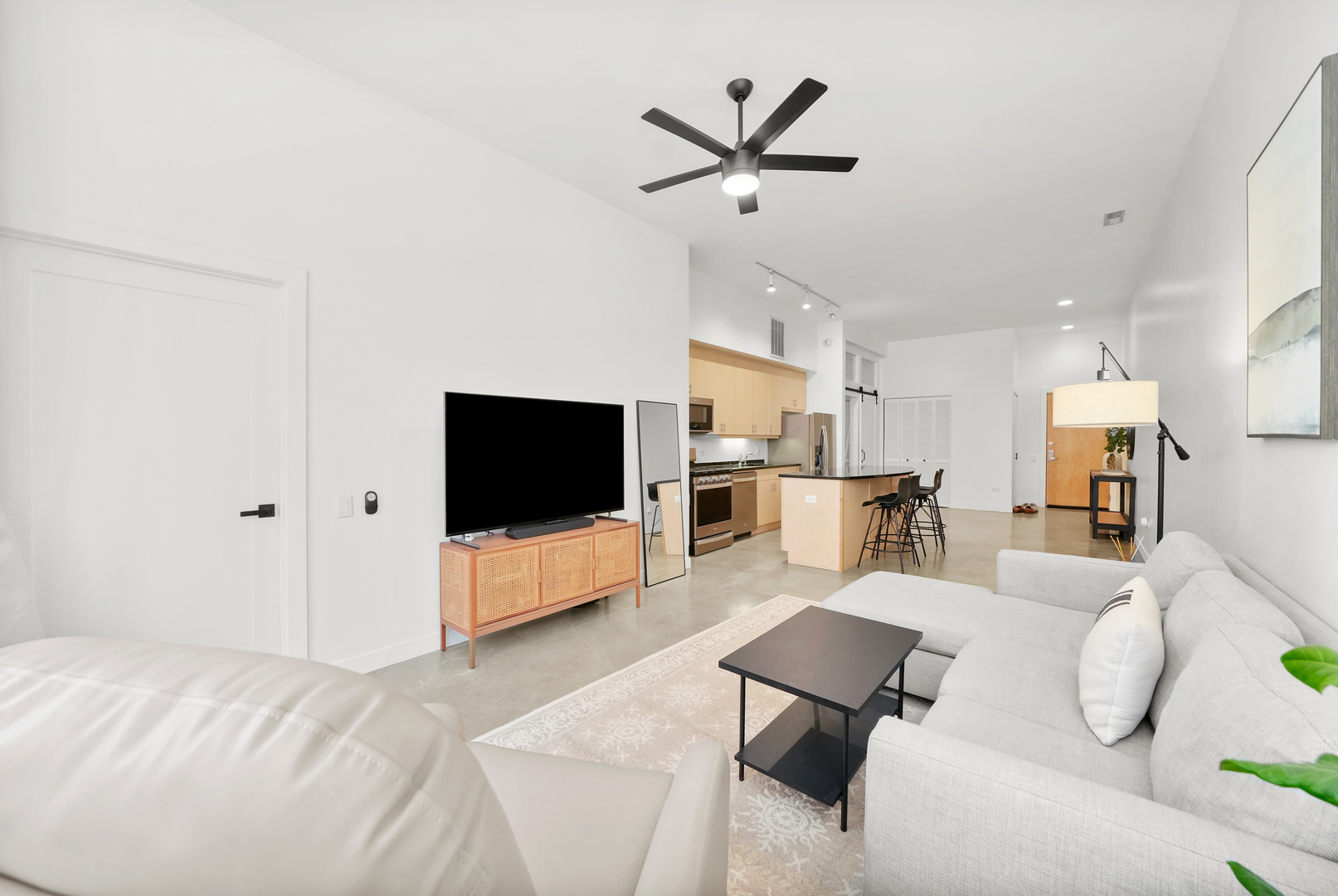 949 West Madison Street, Unit 207 Chicago, IL 60607 - Photo 16 of 31 a living room with furniture and a flat screen tv