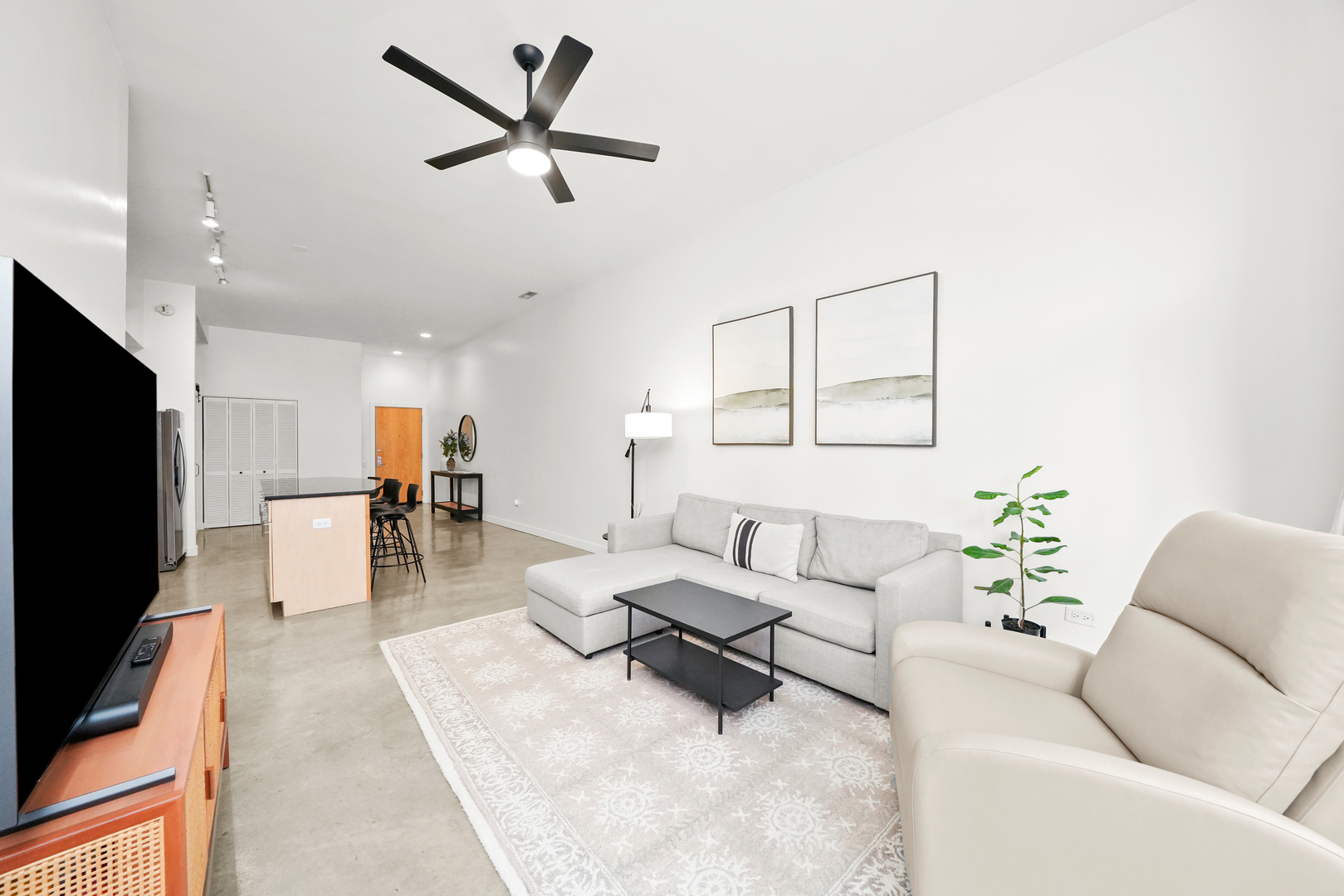 949 West Madison Street, Unit 207 Chicago, IL 60607 - Photo 17 of 31 a living room with furniture and a flat screen tv