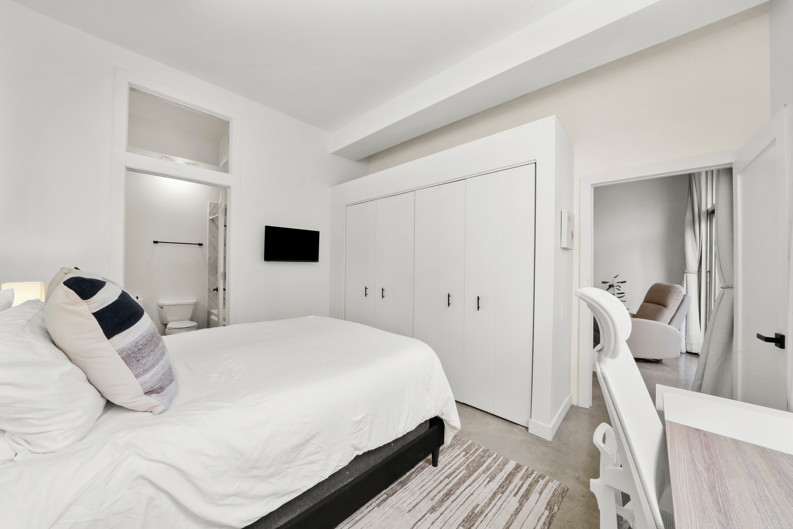949 West Madison Street, Unit 207 Chicago, IL 60607 - Photo 20 of 31 a bedroom with a bed and a flat screen tv