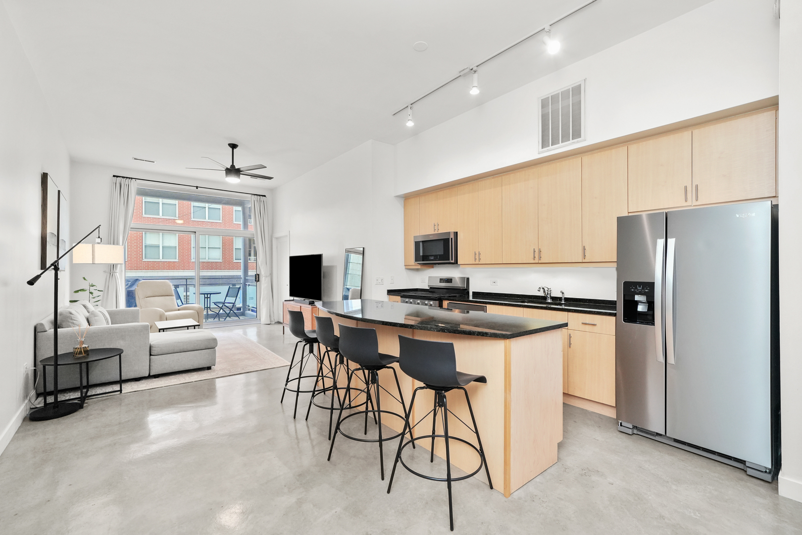 949 West Madison Street, Unit 207 Chicago, IL 60607 - Photo 2 of 31 a kitchen with stainless steel appliances a table and chairs