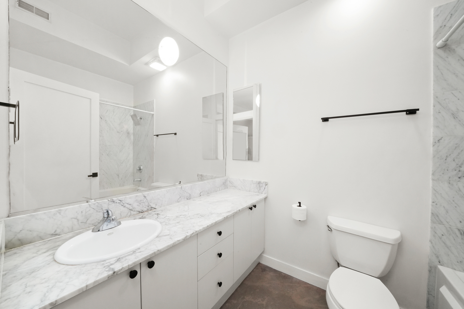 949 West Madison Street, Unit 207 Chicago, IL 60607 - Photo 22 of 31 a bathroom with a granite countertop sink mirror vanity and toilet