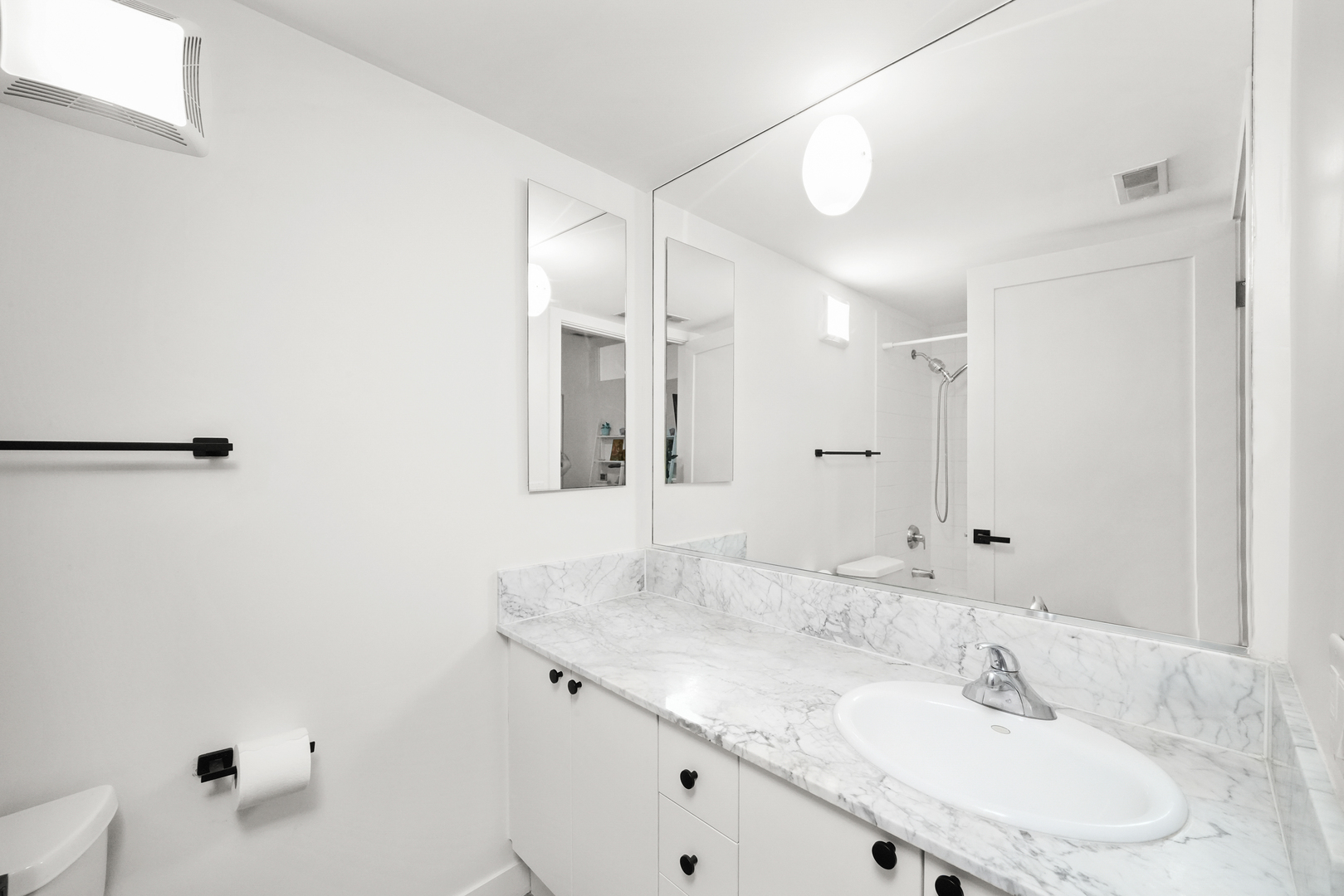 949 West Madison Street, Unit 207 Chicago, IL 60607 - Photo 28 of 31 a bathroom with a granite countertop sink and a mirror