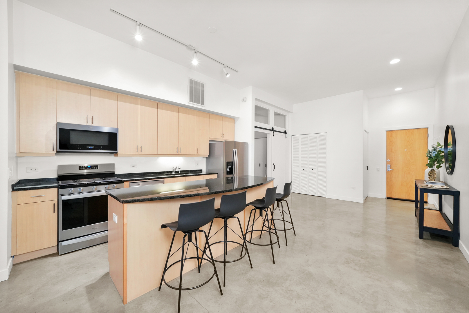 949 West Madison Street, Unit 207 Chicago, IL 60607 - Photo 5 of 31 a kitchen with stainless steel appliances a table chairs microwave and sink