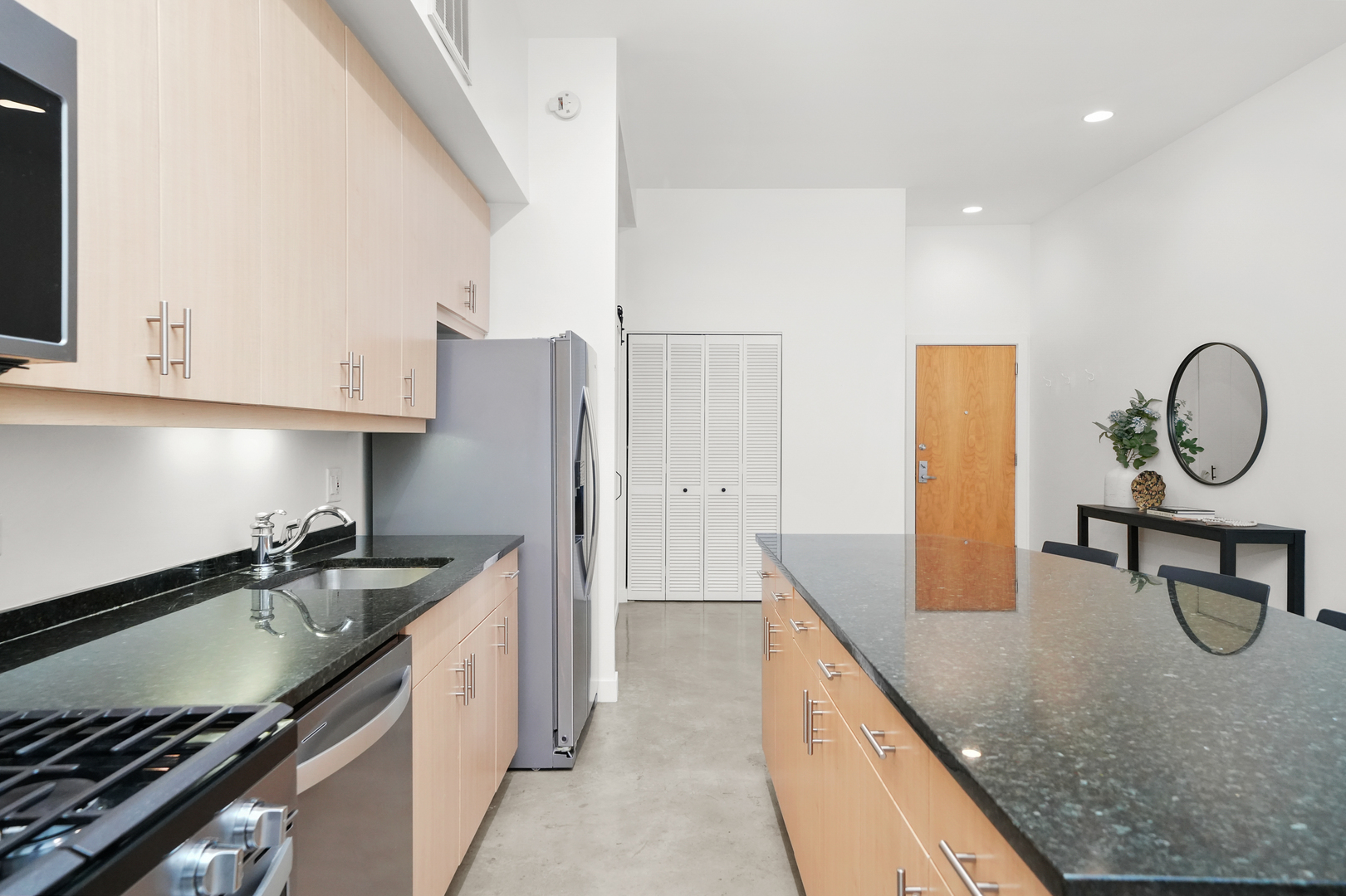 949 West Madison Street, Unit 207 Chicago, IL 60607 - Photo 6 of 31 a kitchen with granite countertop a sink a stove and refrigerator