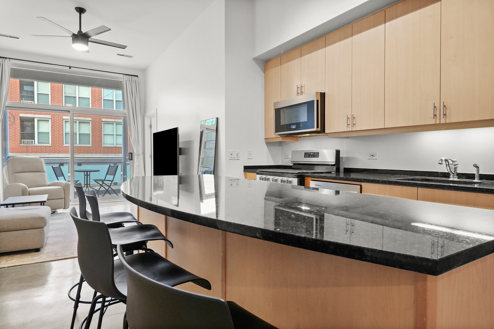 949 West Madison Street, Unit 207 Chicago, IL 60607 - Photo 7 of 31 a kitchen with stainless steel appliances granite countertop a sink counter space and cabinets