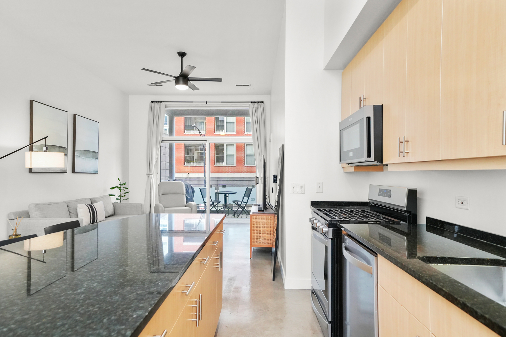949 West Madison Street, Unit 207 Chicago, IL 60607 - Photo 8 of 31 a kitchen with granite countertop a stove a sink and a refrigerator