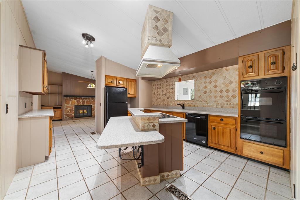 13601 Highway 377 Brookesmith, TX 76827 - Photo 7 of 35 a kitchen with stainless steel appliances granite countertop a stove a sink and a refrigerator