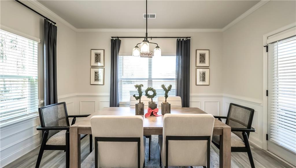 213 Laney Drive Carrollton, GA 30117 - Photo 11 of 36 a dining room with furniture a chandelier and wooden floor
