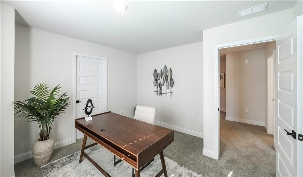 213 Laney Drive Carrollton, GA 30117 - Photo 16 of 36 a living room with furniture and a potted plant